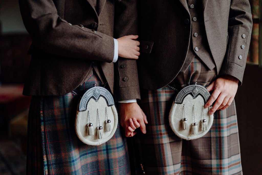 Two men wearing kilts